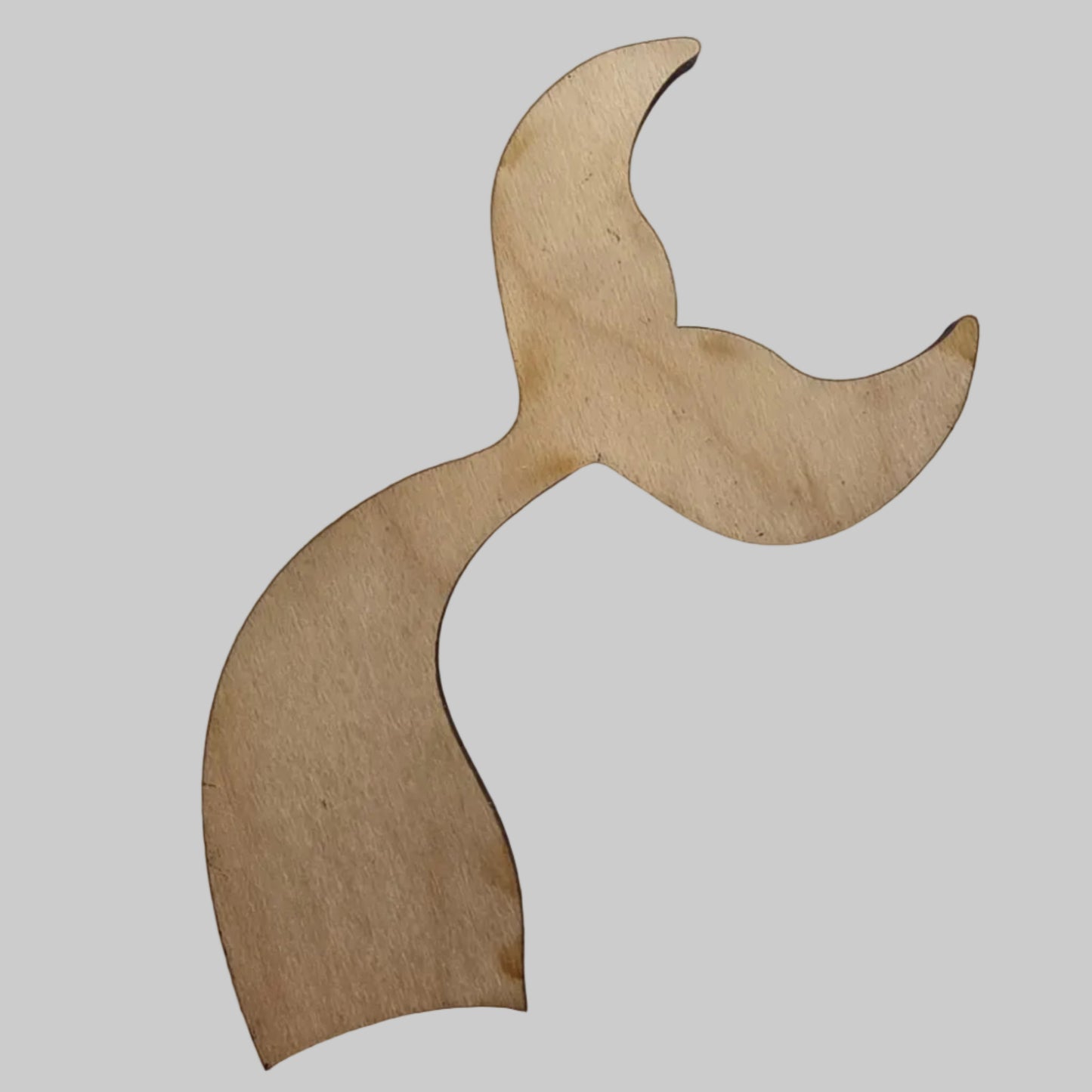 Wooden mermaid tail shape on a white background