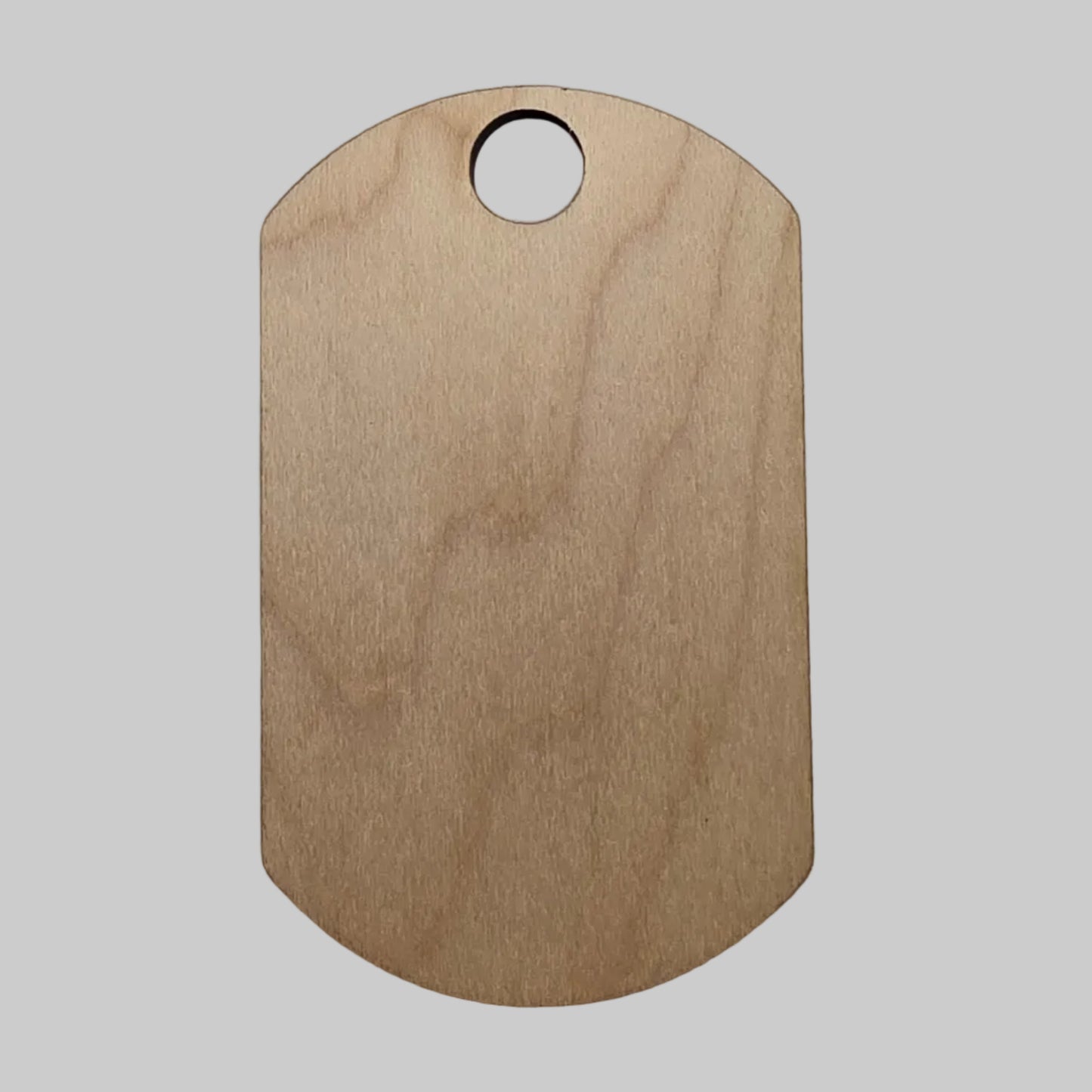 Wooden military dog tag on a light gray background