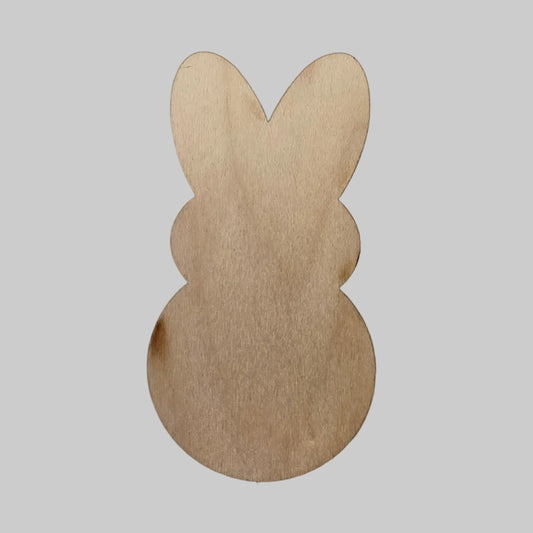 Wooden candy bunny-shaped cutout on a white background.