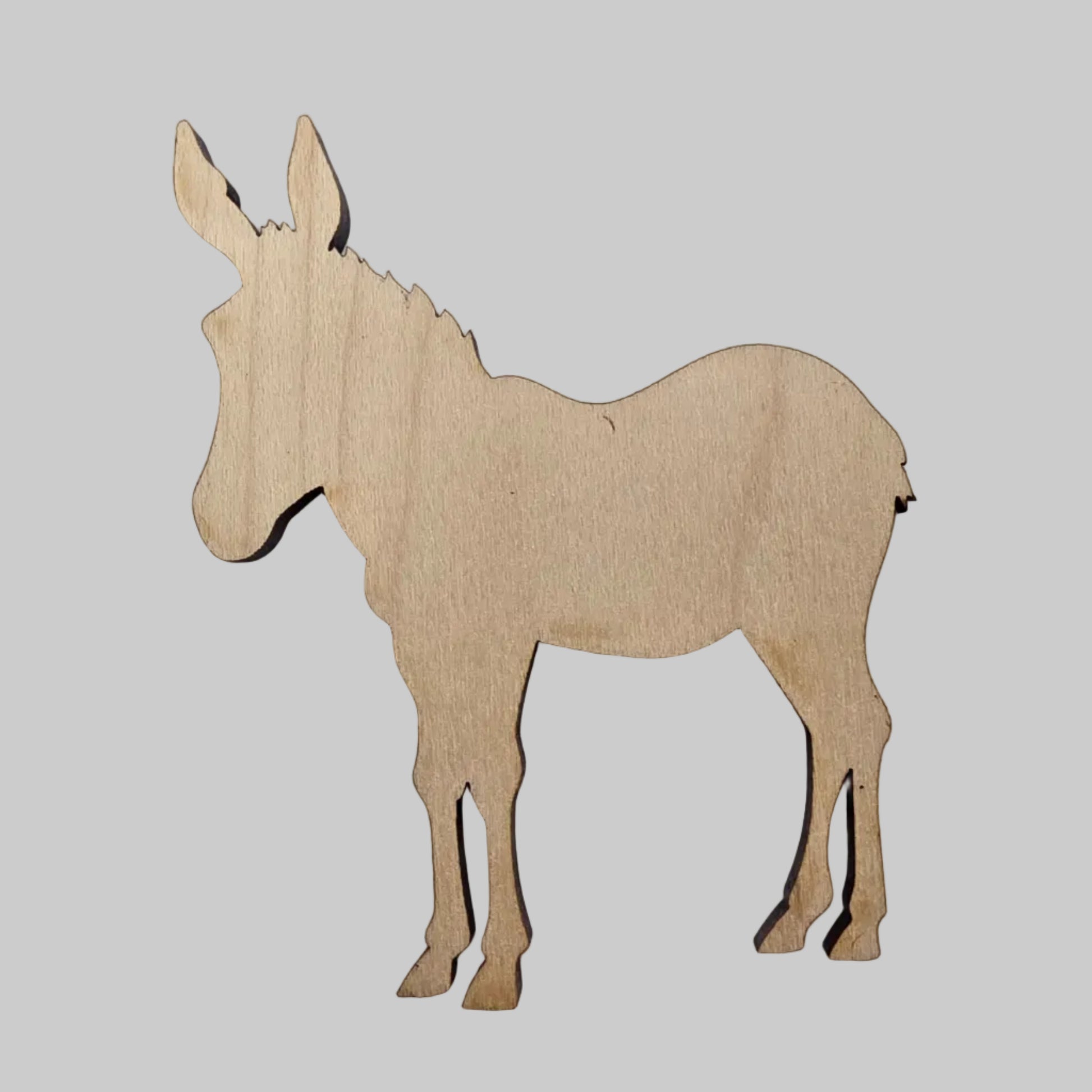 Wooden cutout of a donkey on a white background