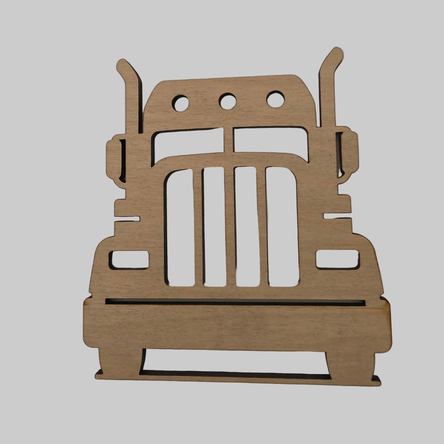Wooden cutout of a truck shape on a plain background