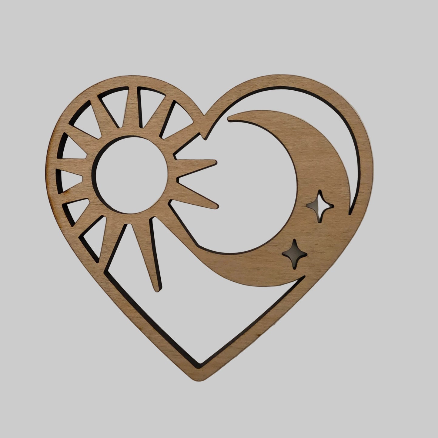 Wooden decorative cutout with moon, star, and geometric design on a beige background