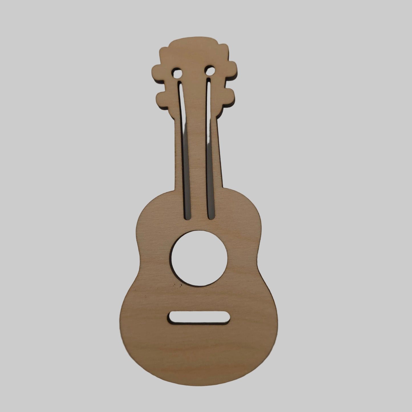 Wooden ukulele-shaped cutout on a plain background