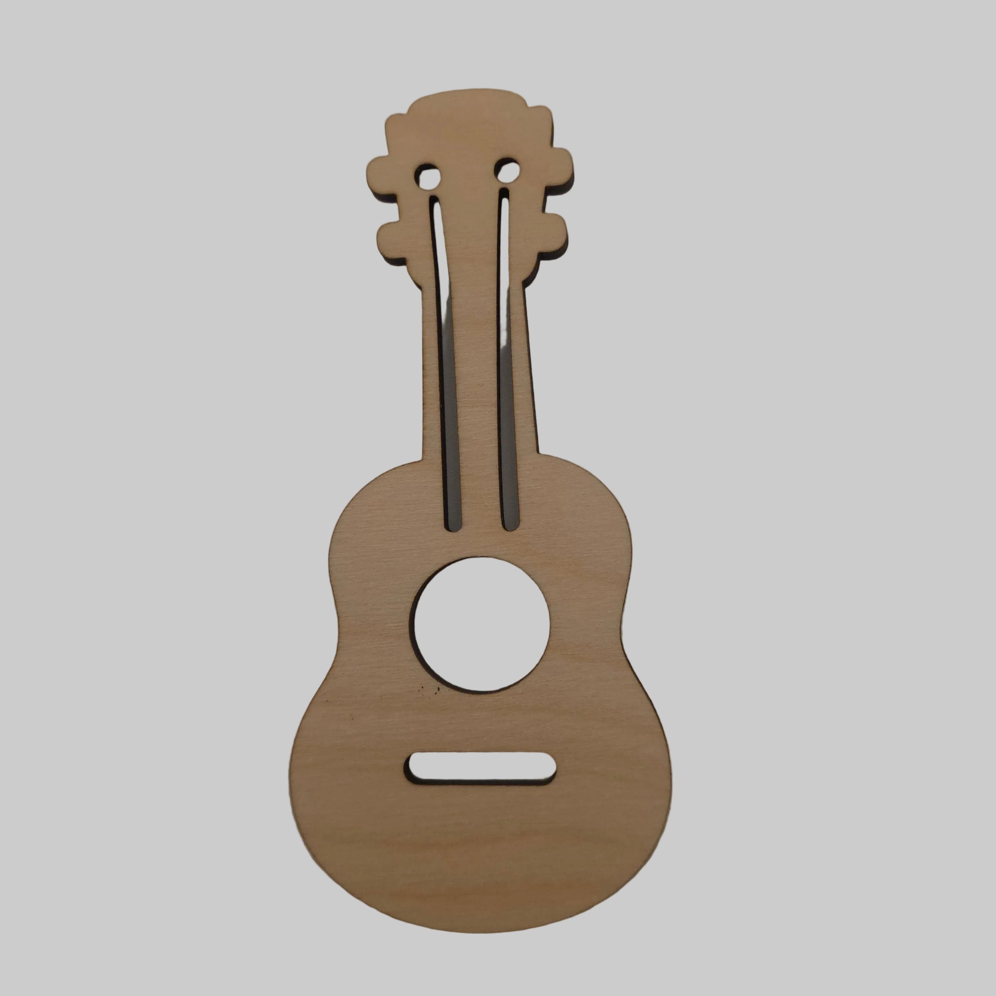 Wooden ukulele-shaped cutout on a plain background