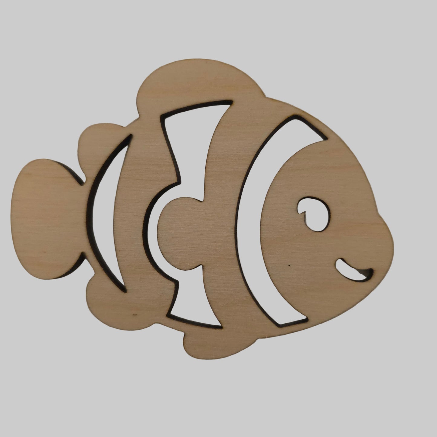Wooden cutout of a fish shape on a beige background