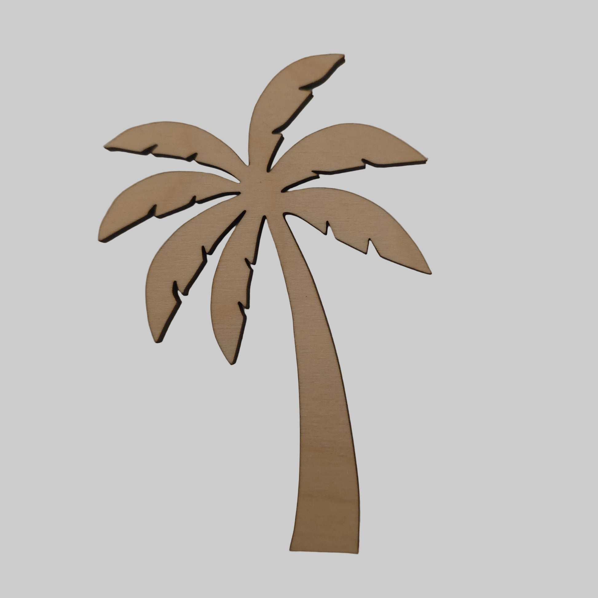 Wooden palm leaf decoration on a plain background
