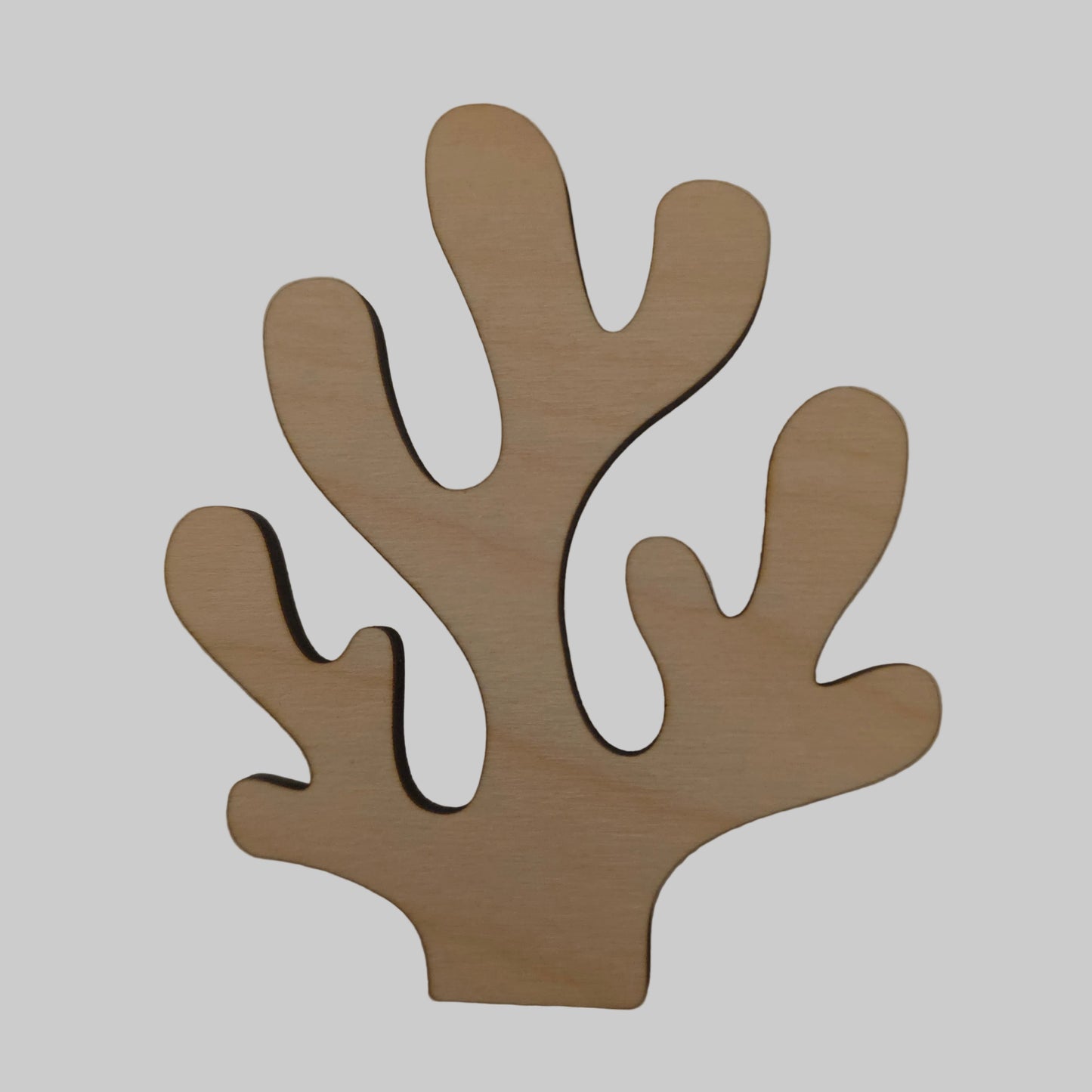 Wooden coral shape on a beige background