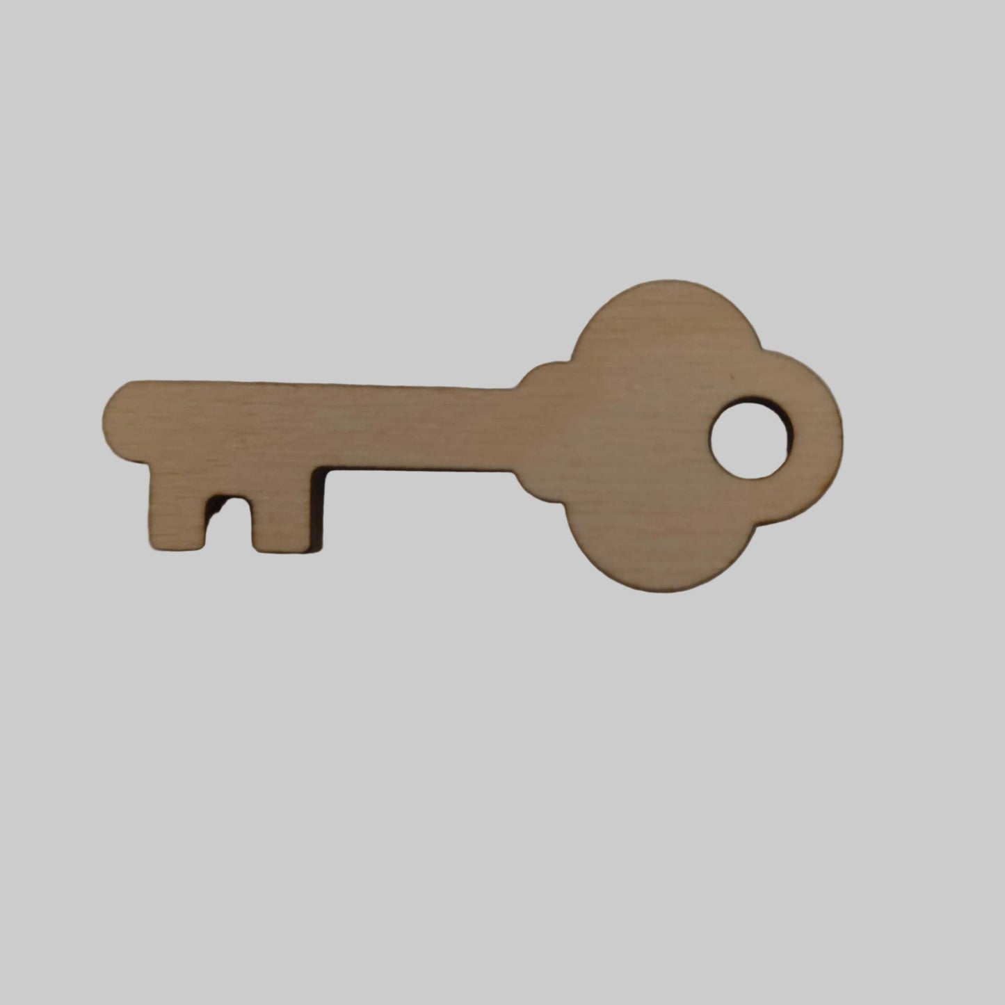 Wooden key-shaped object on a beige background