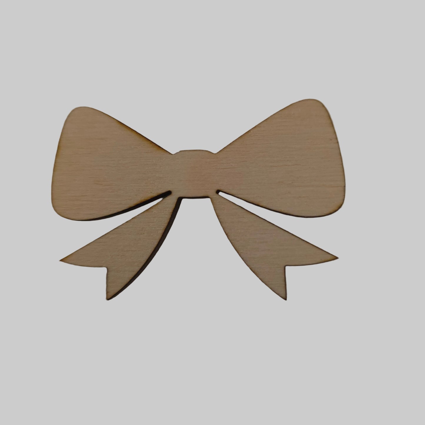 Wooden bow-shaped object on a beige background