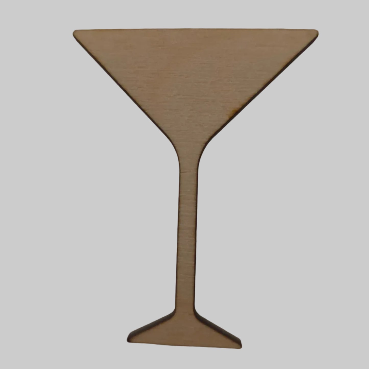 Wooden martini glass cutout on a beige background