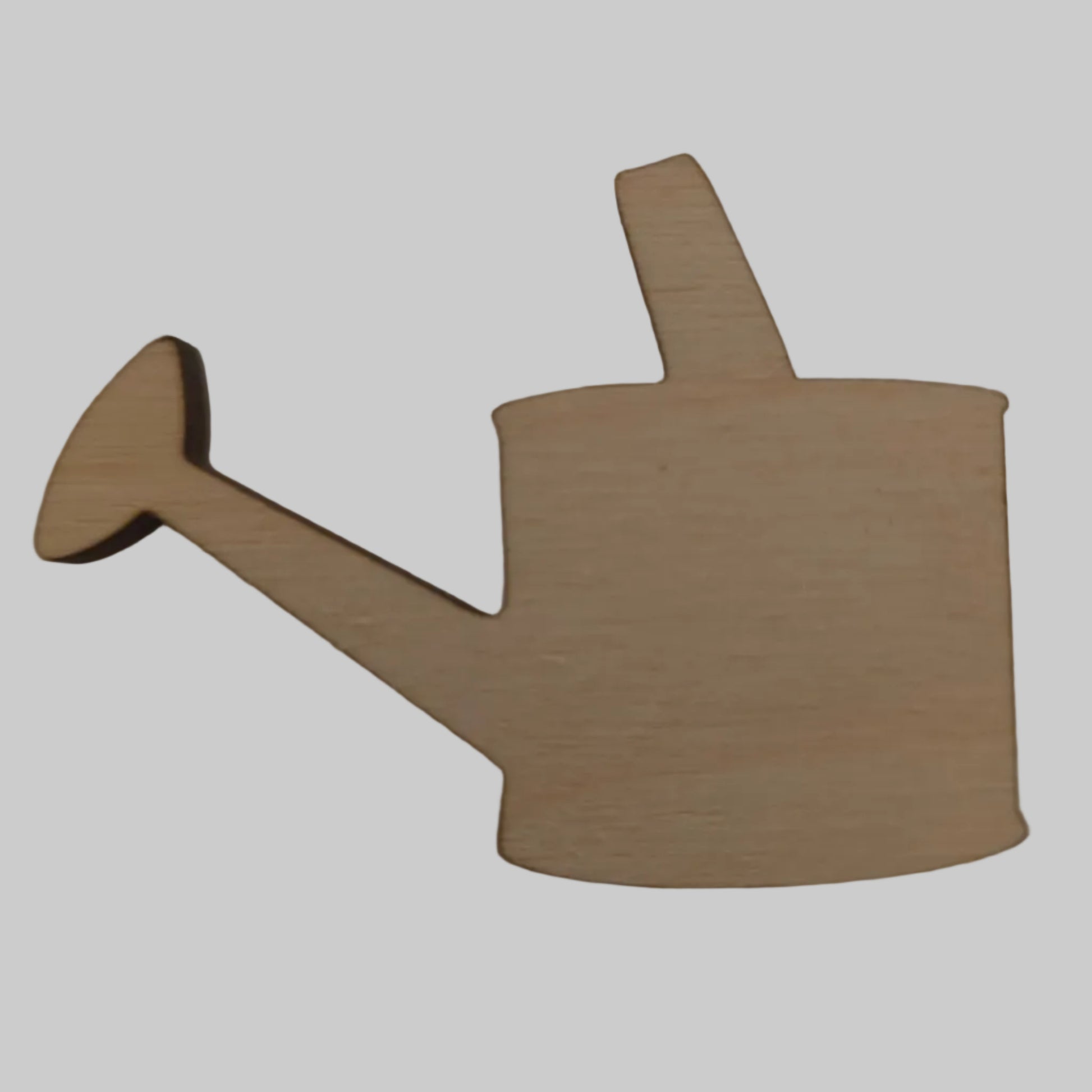 Wooden cutout of a watering can on a plain background