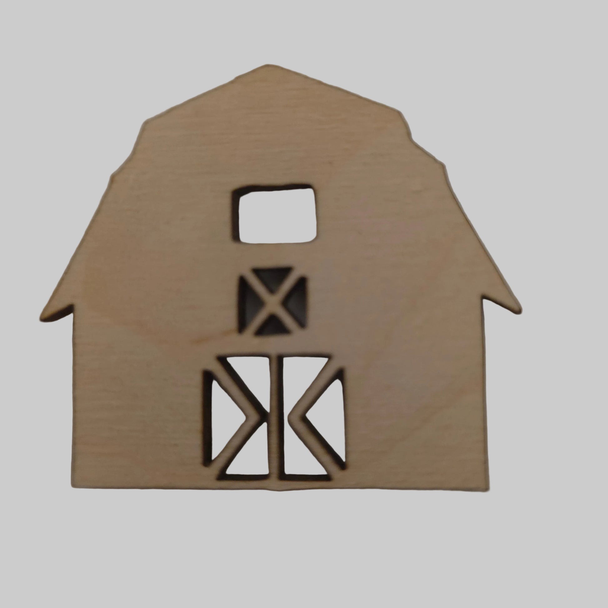 Wooden barn-shaped cutout on a plain background
