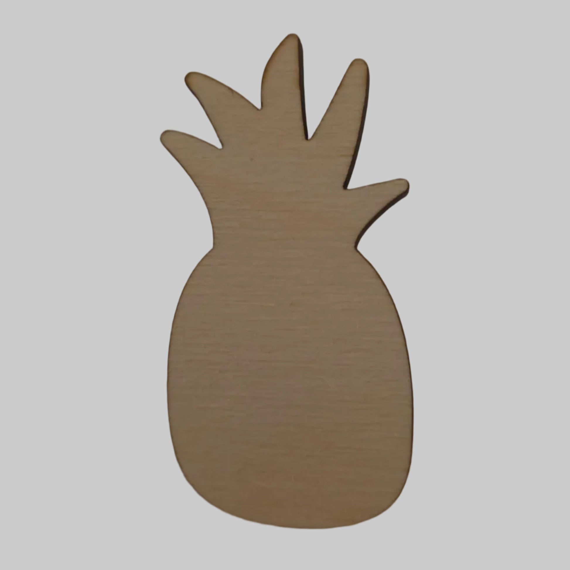 Wooden pineapple-shaped object on a beige background