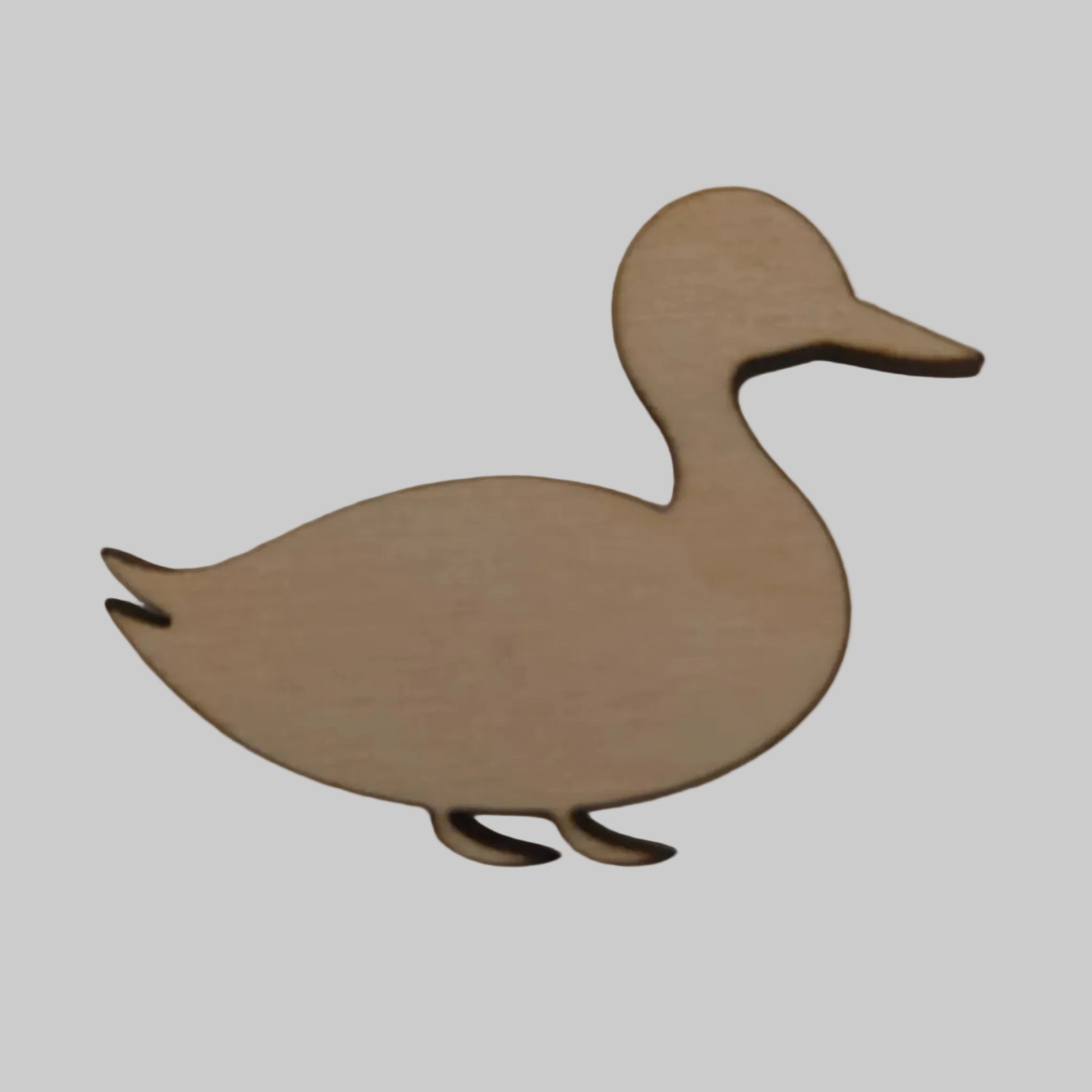 Wooden cutout of a duck shape on a plain background