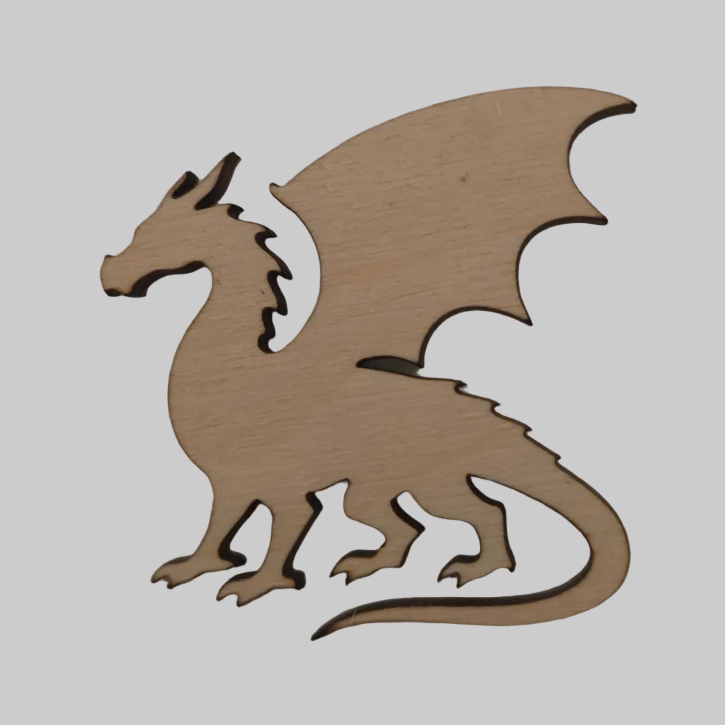 Wooden dragon cutout on a beige background