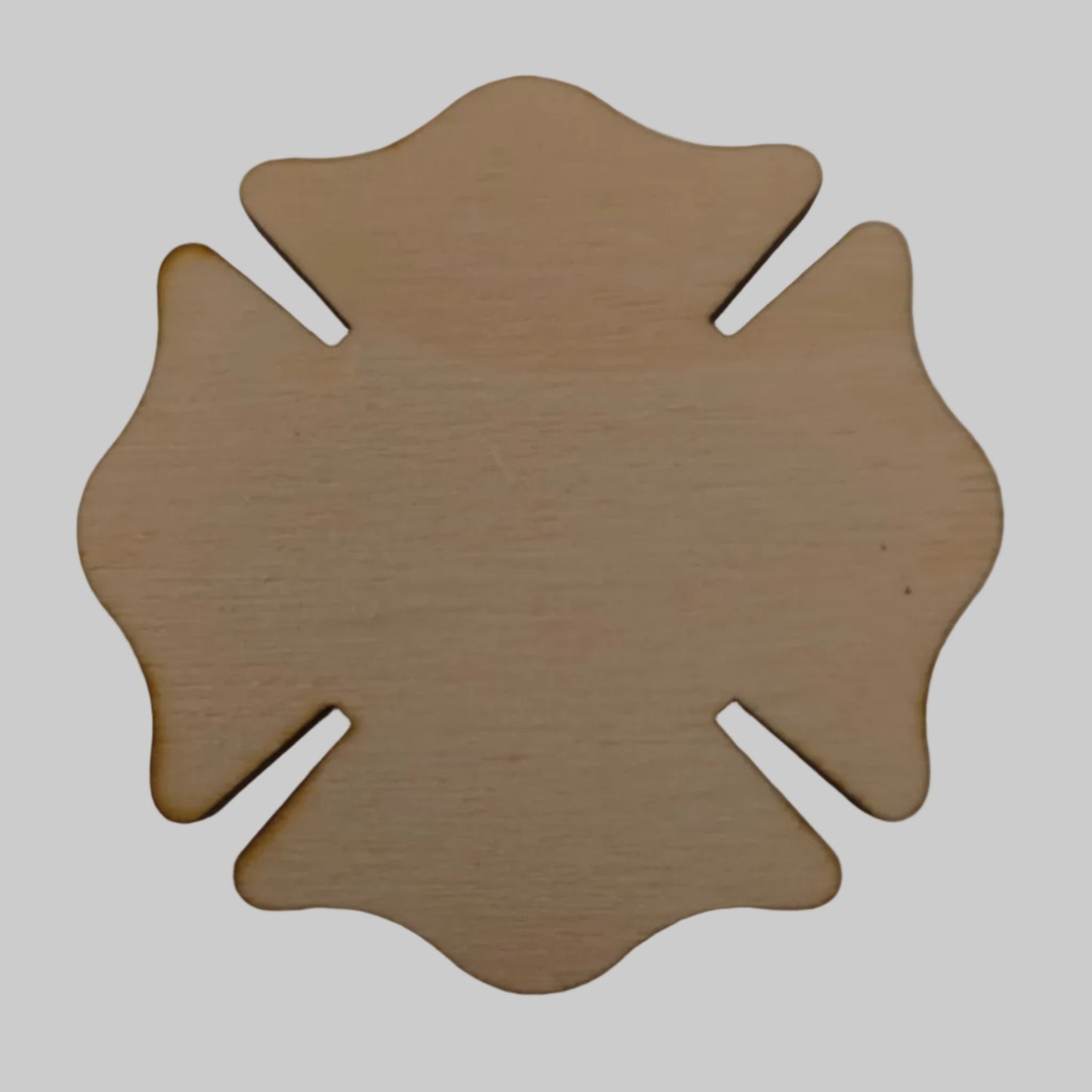 Wooden Maltese cross-shaped object on a plain background
