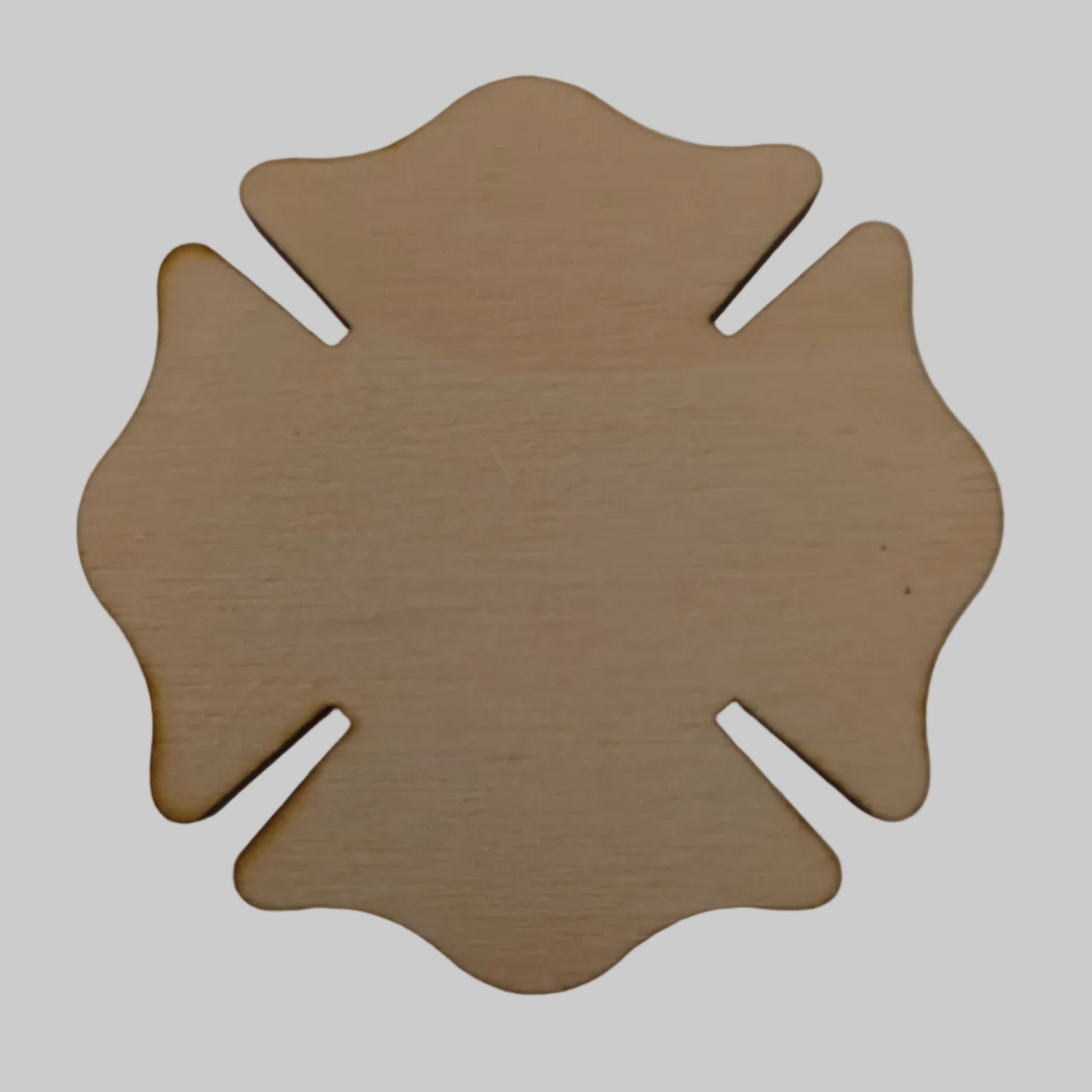 Wooden Maltese cross-shaped object on a plain background
